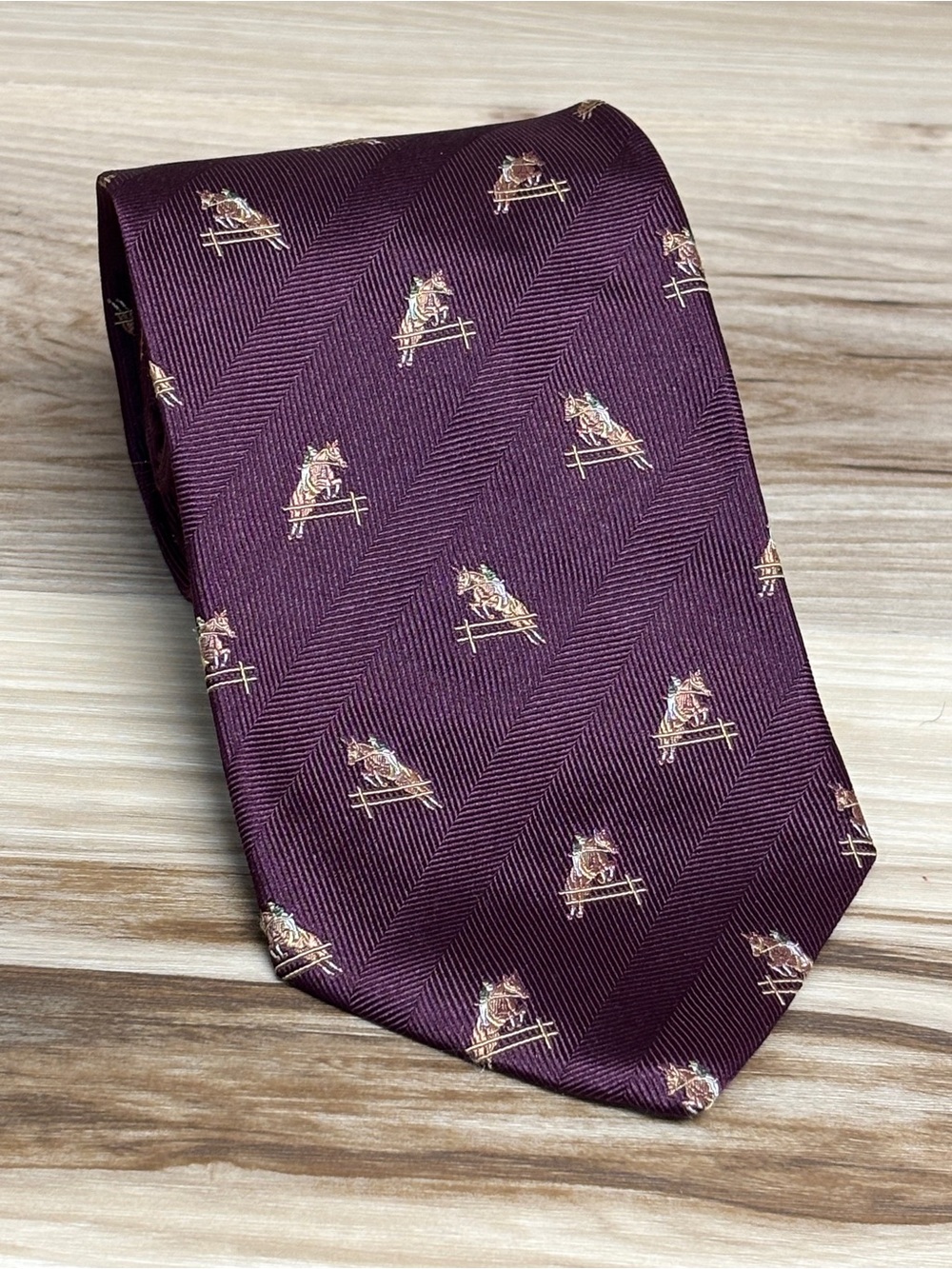 Brooks Brothers burgundy with stitched in horses tie.